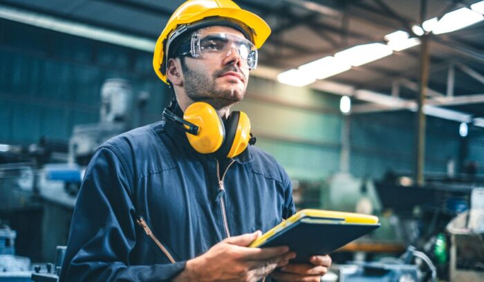 Ingeniero industrial analizando procesos y operaciones para mejorar la eficiencia en una empresa.